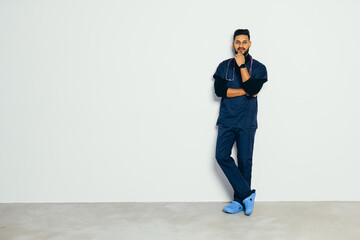 medicine, profession and healthcare concept - smiling indian male doctor iwith stethoscope over grey background