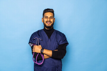Handsome modern Indian doctor with stethoscope, in uniform on blue background medicine, healthcare and people concept