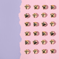 Creative layout with jingle bells Christmas decoration pattern on pastel pink and purple background. 80s or 90s retro fashion aesthetic concept. Minimal New Year or Christmas celebration idea.