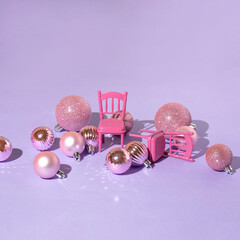 Creative layout with pink Christmas baubles and restaurant chairs on pastel purple background. 80s...