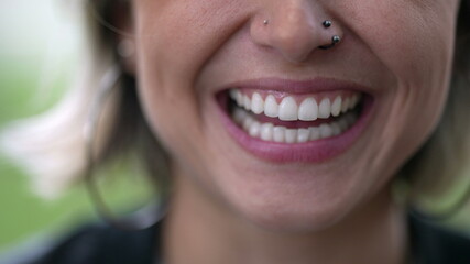 Happy woman close-up lips smiling and laughing, talking in conversation
