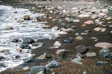 Foamy sea waves washing sandy shore