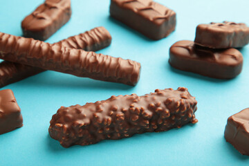 Mix of chocolate bars on blue background. Top view.