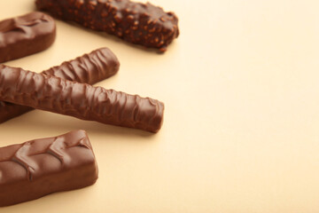 Mix of chocolate bars on beige background. Top view.