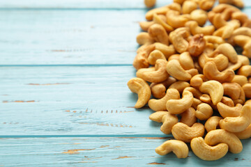 Cashew nuts on blue wooden background. Top view.