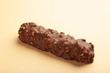 Chocolate bar on beige background. Sweety snack