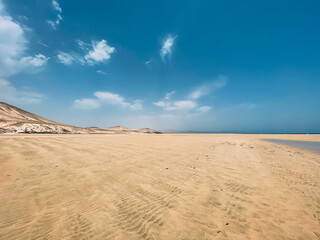 Fototapeta na wymiar Sandy hill under cloudy sky