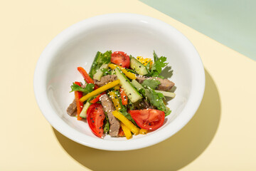Grilled Beef Steak salad with greens vegetables. Healthy food. Hard shadows