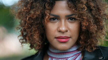 Fototapeta premium Brazilian black woman portrait close-up face looking at camera with curly hair
