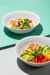Fresh Avocado, shrimps salad with lettuce green mix, cherry tomatoes, herbs and olive oil, lemon dressing. healthy food