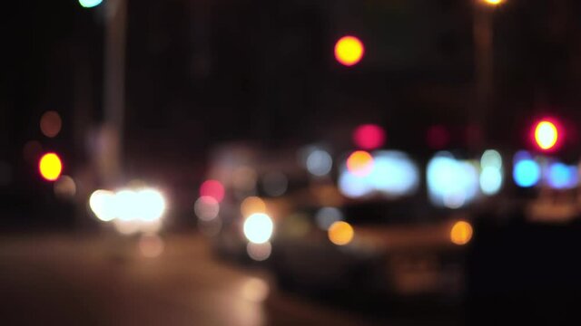 Unfocused red and blue car emergency lights at night in the city.
