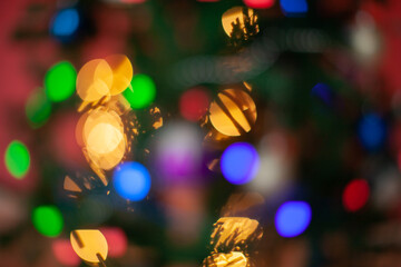 Christmas, blurred bokeh of Christmas lights on the Christmas tree, New Year.