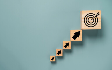 Virtual target board and arrow which print screen on wooden cube. Business achievement goal and...