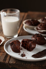 Food photo. Chocolate muffins and a glass of milk on a wooden background
