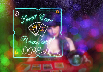 Tarot Card Readings Neon Sign in Window with Psychic Tarot Card Reader in background