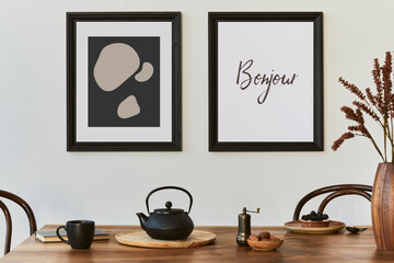 Stylish composition of modern kitchen interior design with mock up poster frames, black console, teapot and kitchen accessories. Template. Autumn vibes..