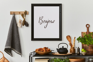 Stylish and cozy kitchen interior composition with mock up poster frame, black console, kitchen...