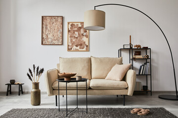 .Creative composition of modern living room interior with mock up poster frames, beige sofa, side table and stylish small personal accessories on metal shelf. Template.