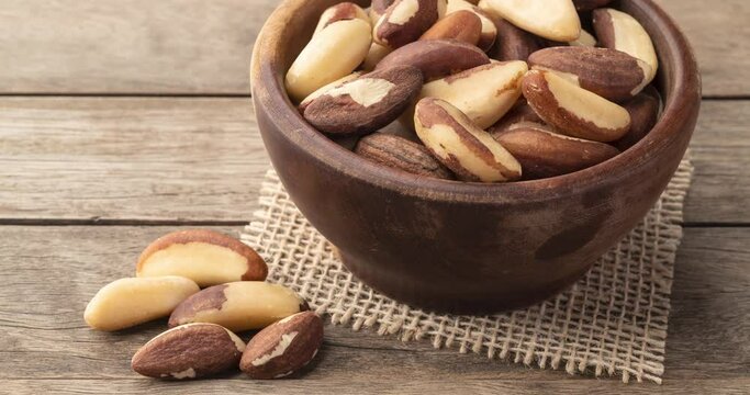 Brazil nuts in a bowl over wooden table