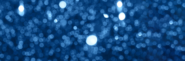 Blue sparkling glitter bokeh background, christmas texture. Holiday lights. Abstract defocused header. Wide screen wallpaper. Panoramic web banner with copy space for design