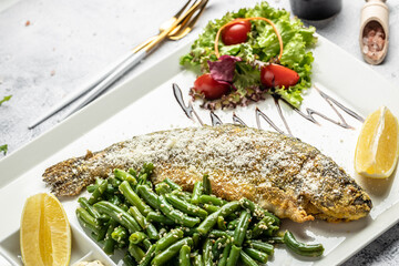 Baked trout fish with parmesan, lemon and vegetables. banner, menu, recipe place for text, top view