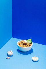 Fototapeta na wymiar Traditional Uzbek oriental cuisine rice with meat plov on blue hair shadow modern style.