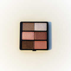 Mini palette of bronze and pink eyeshadows. Isolated image on a white background. Nobody