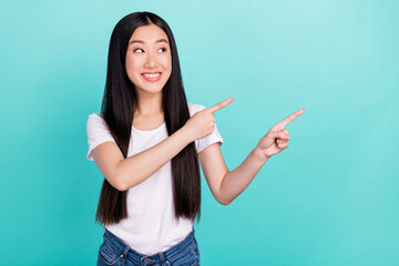 Photo of young asian girl happy positive smile point fingers empty space subscribe ad select...