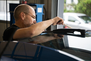Professional Paintless Dent Repair Technician Is Repairing Dents On Car Body. Man Removing Dent On...