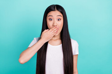 Portrait of attractive stunned long-haired girl closing mouth wow isolated over bright teal turquoise color background