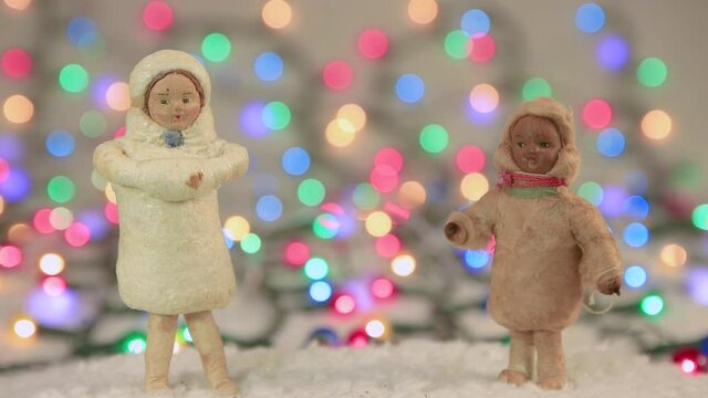 Screensaver Snow Maiden and a dark-skinned girl on the background of lights. Copy space. Multicolored lights out of focus. Beautiful footage, video for intro, transition, intro. UHD 4K.