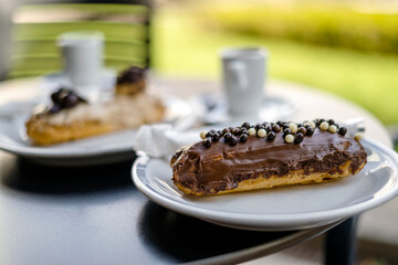 Tasty eclair pastry filled and covered  with chocolate