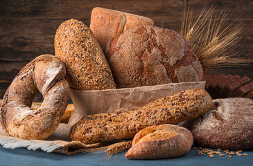 Different types of bread close-up on a wooden background.
