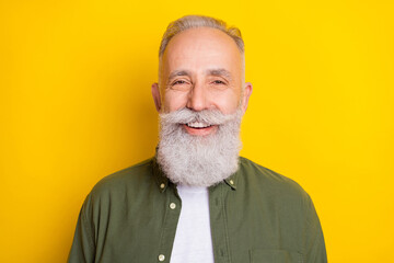 Photo portrait of senior man smiling happy isolated on bright yellow color background