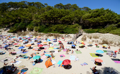 The small beaches of Menorca are very crowded with tourists in August.