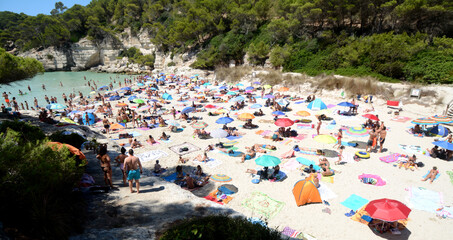 The small beaches of Menorca are very crowded with tourists in August.