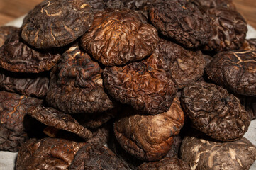 Dried mushrooms in a container on a wooden countertop