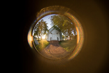 Beautiful view from the peephole to the house with large trees - obrazy, fototapety, plakaty