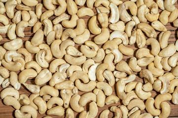 Dried cashew nuts in containers on wooden countertops