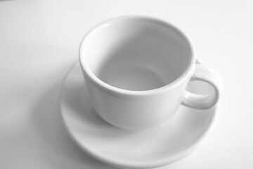 Empty white coffee cup and saucer on white background