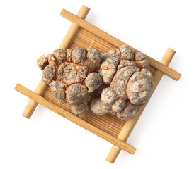 Dried notoginseng root in the bamboo mat, isolated on white background, top view
