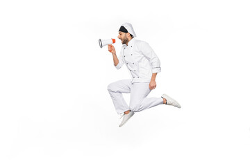 Obraz premium side view of young chef in hat and uniform levitating and speaking in megaphone isolated on white.