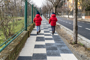 Children walking on sidewalk