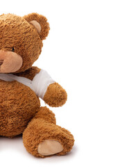 medicine, healthcare and childhood concept - teddy bear toy with bandaged paw on white background
