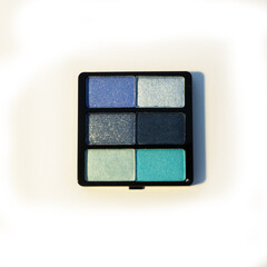 Mini palette of blue eyeshadows. Isolated image on a white background. Nobody.