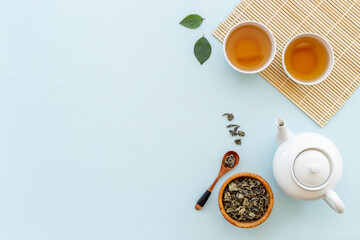 Asian tea set with white teapot and two cups, top view - obrazy, fototapety, plakaty
