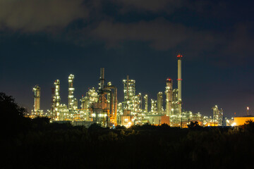 Obraz na płótnie Canvas Oil​ refinery​ and​ plant and tower of Petrochemistry industry in oil​ and​ gas​ ​industry with​ cloud​ blue​ ​sky the night