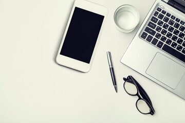 Modern smartphone with a blank screen and laptop