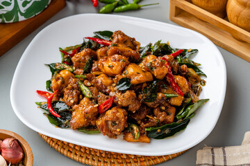 Ayam Tangkap, spices fried chicken original from Aceh, Indonesia. served with leaves such as...