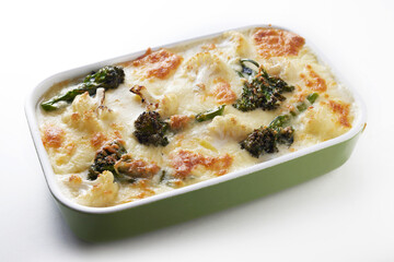 Appetizing traditional French broccoli and vegetable gratin served on table